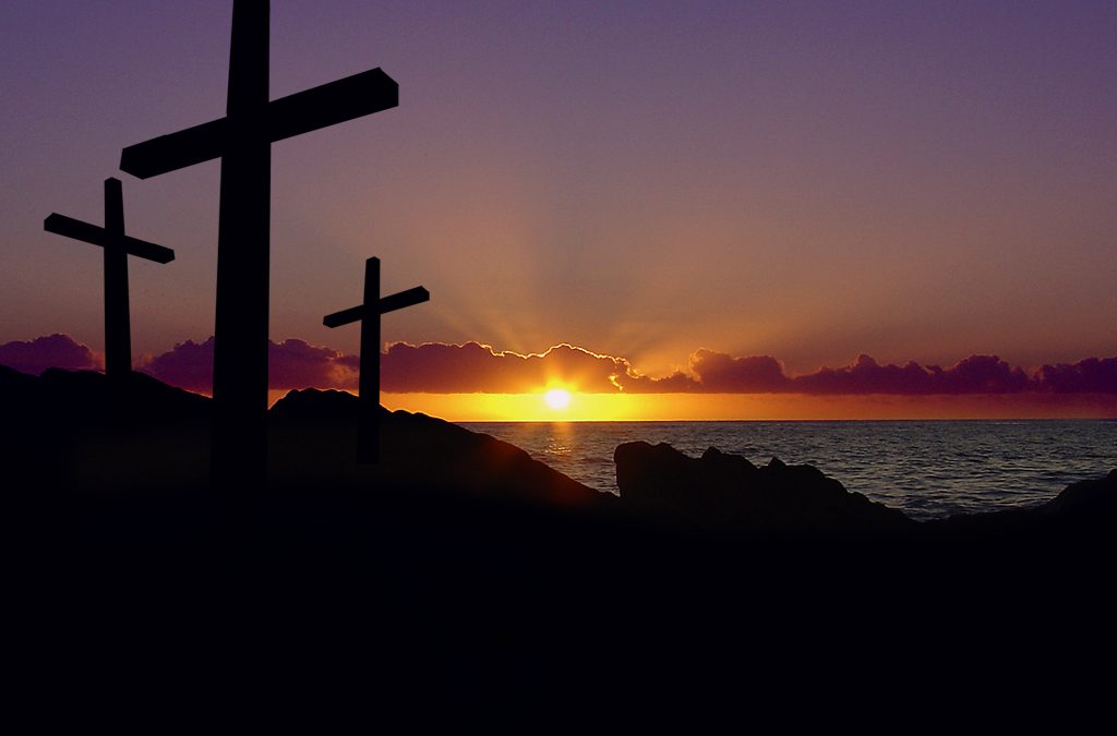 Three crosses with sunset.