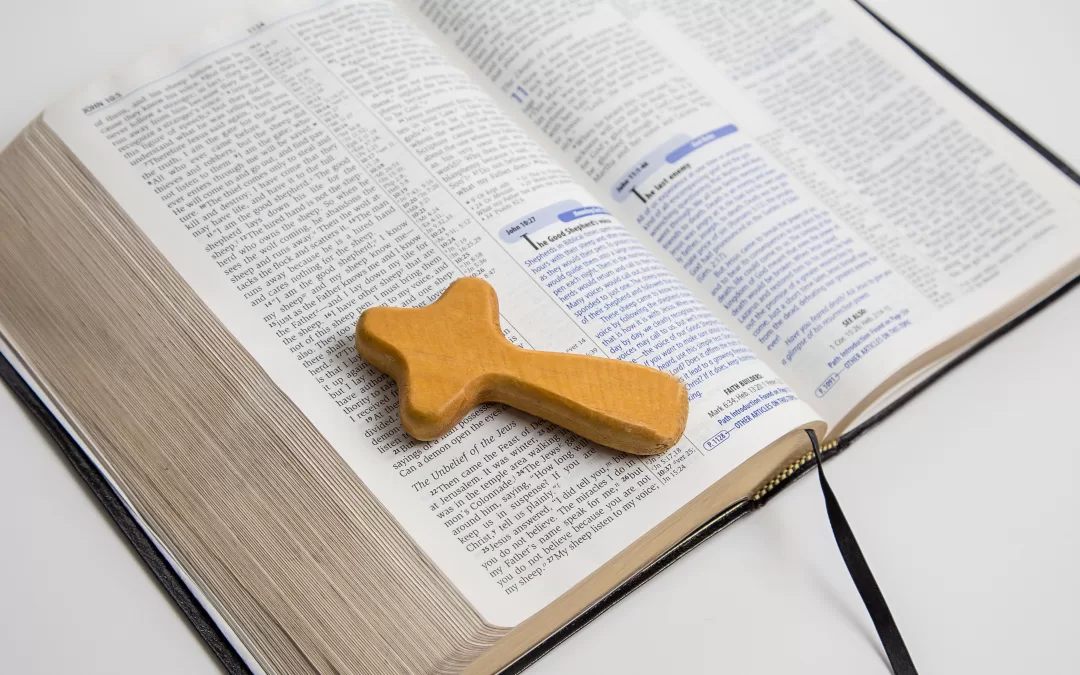 open bible with wooden cross