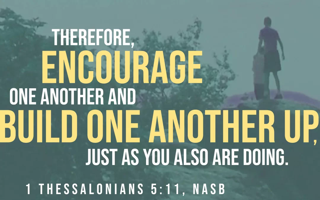 Photo of two people standing on a rock with overlay text of "Therefore encourage one another and build one another up, just as you also are doing." 1 Thessalonians 5:11 (NASB)