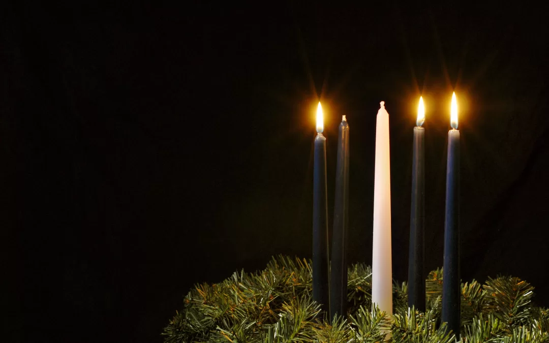 Three candles lit on the advent wreath.